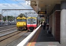 BL 34 running "light engine" waits to follow a spark back to Melbourne whilst Sprinter railcar 7013 is about to depart for Stony Point. Oct 19 2009