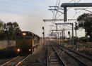 A down, (northbound) QR National goods powers through Somerton on the standard gauge. Jan 6 2011
